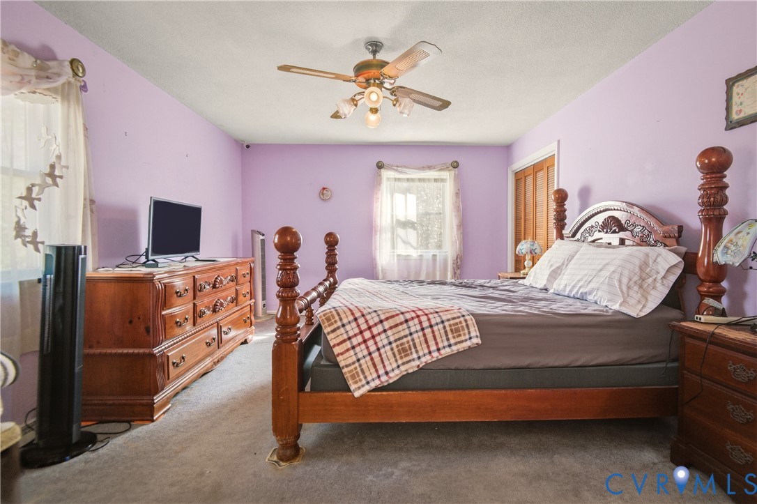 3124 West Hundred Road Chester, VA 23831 - Photo 15 of 28 a bedroom with a bed and a flat tv screen on dresser