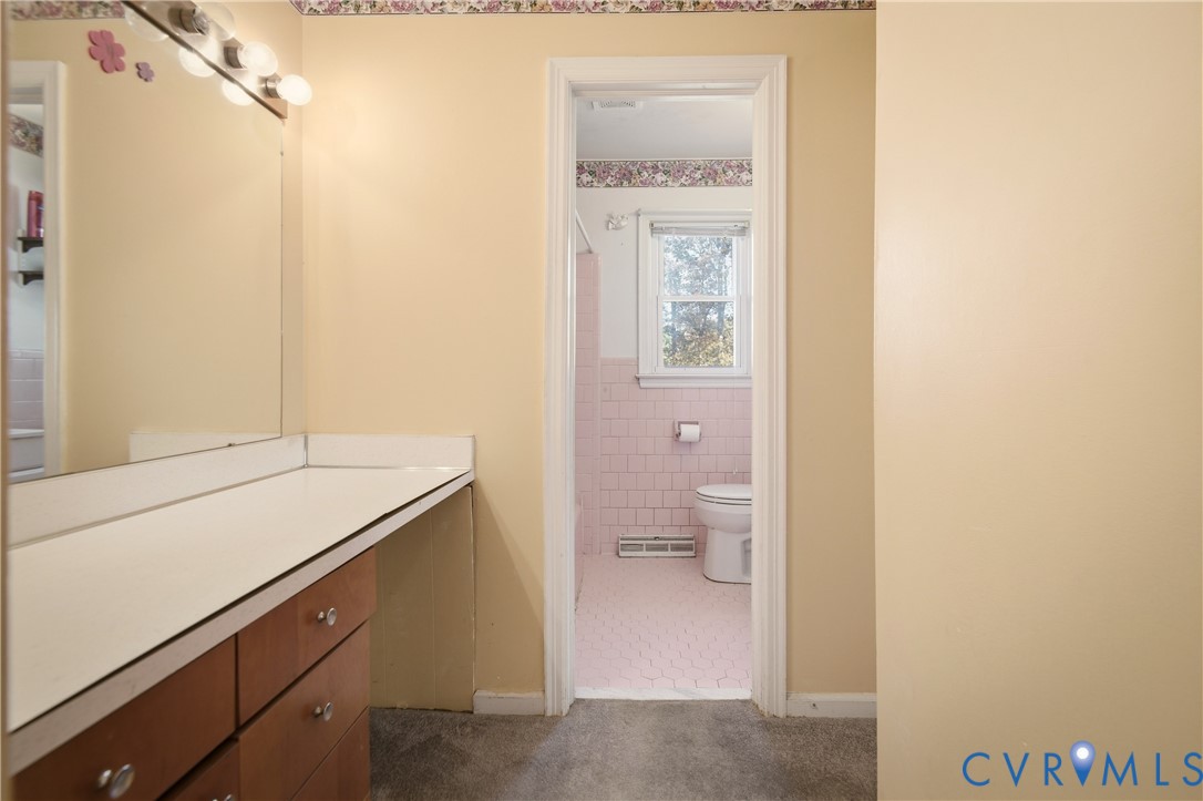 3124 West Hundred Road Chester, VA 23831 - Photo 18 of 28 a bathroom with a granite countertop sink a toilet and a shower