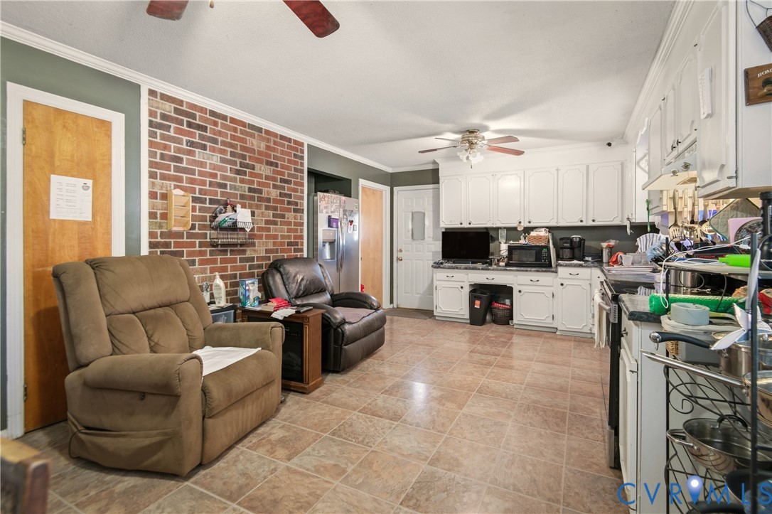 3124 West Hundred Road Chester, VA 23831 - Photo 10 of 28 a living room with furniture a fireplace and a chandelier