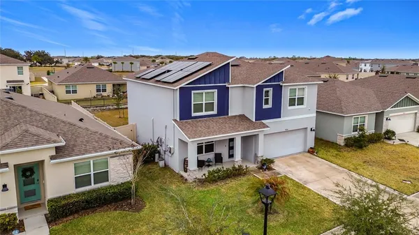 a kitchen with stainless steel appliances kitchen island granite countertop a refrigerator a stove a microwave oven a sink dishwasher and white cabinets with wooden floor