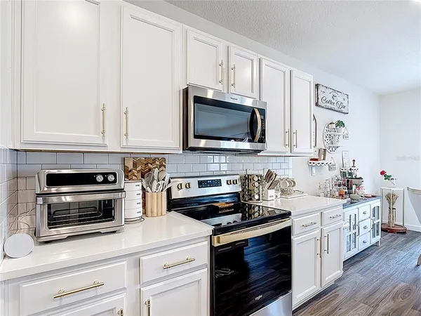 a bedroom with a bed and a flat tv screen on wall
