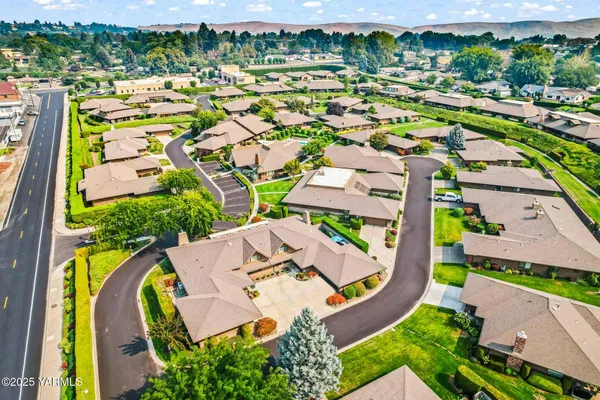 an aerial view of residential house with outdoor space and swimming pool