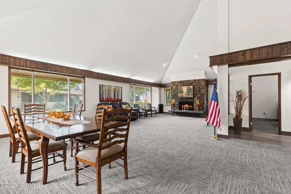 a dining room with furniture and a floor to ceiling window