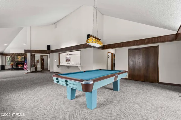 a room with furniture and pool table