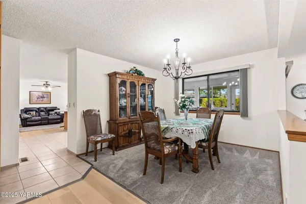 a view of a dining room with furniture and chandelier