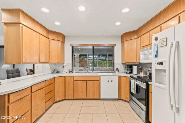 a kitchen with stainless steel appliances granite countertop a sink and cabinets