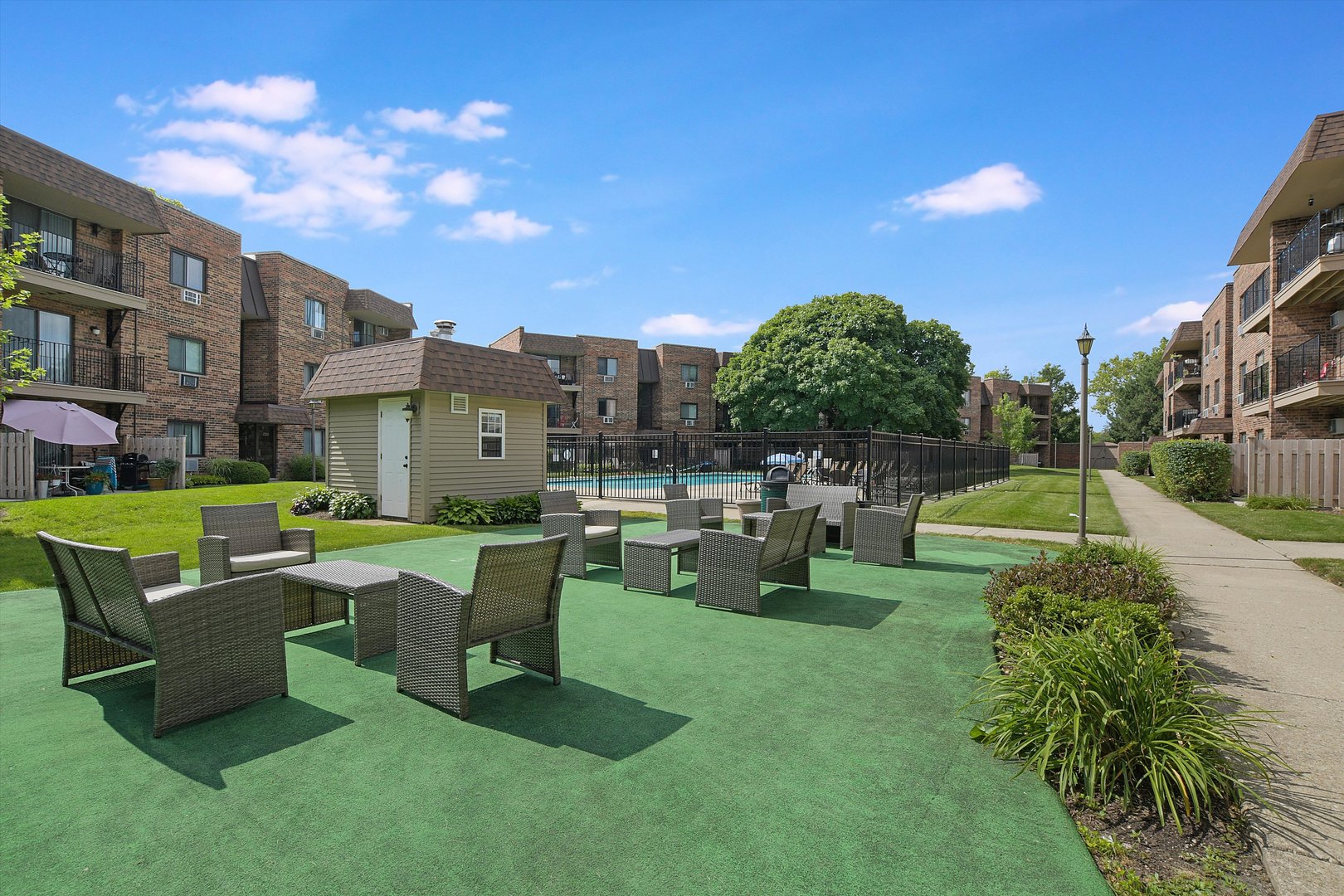 3523 Central Road, Unit 203 Glenview, IL 60025 - Photo 23 of 26 a view of a swimming pool and lounge chairs in the patio