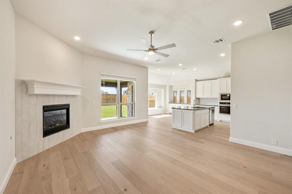 204 Sweetwater Drive Commerce, TX 75428 - Photo 16 of 38 a view of kitchen with furniture and a fireplace