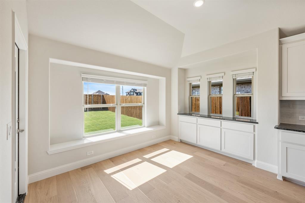 204 Sweetwater Drive Commerce, TX 75428 - Photo 21 of 38 a view of an empty room with a window and wooden floor