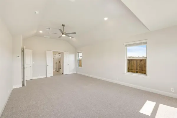 an empty room with a window and a ceiling fan