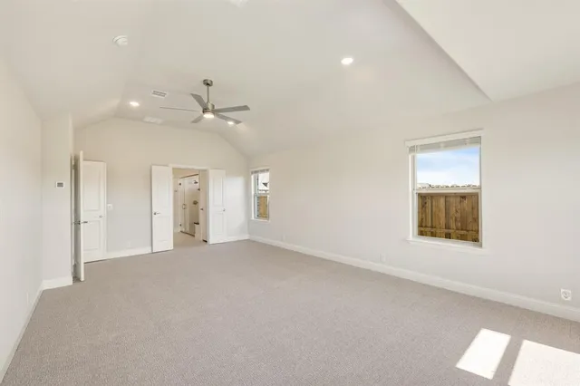 an empty room with a window and a ceiling fan