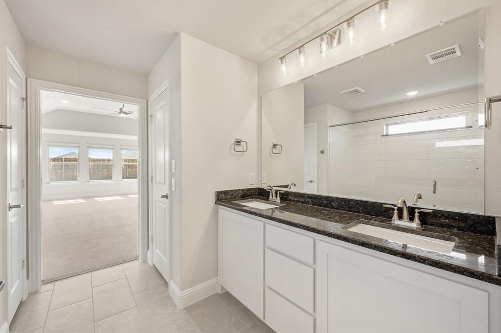 204 Sweetwater Drive Commerce, TX 75428 - Photo 24 of 38 a bathroom with a granite countertop sink and a mirror