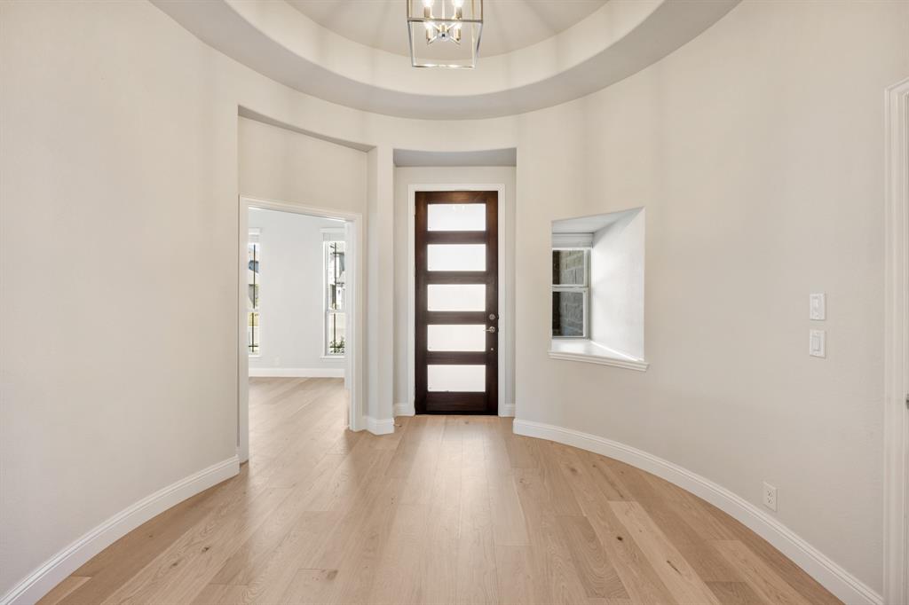 204 Sweetwater Drive Commerce, TX 75428 - Photo 3 of 38 wooden floor in an empty room with a window