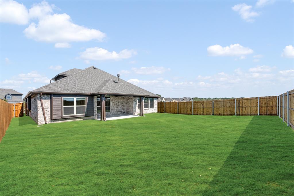 204 Sweetwater Drive Commerce, TX 75428 - Photo 37 of 38 a view of a big house with a big yard and large trees