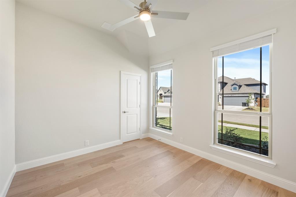 204 Sweetwater Drive Commerce, TX 75428 - Photo 4 of 38 wooden floor in an empty room with a window