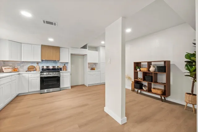 a kitchen with granite countertop a stove and a refrigerator
