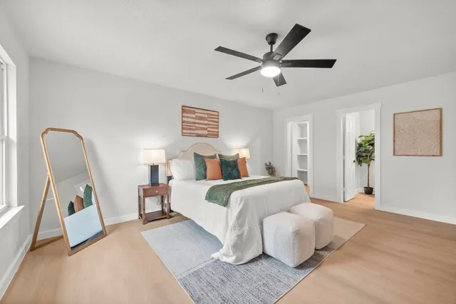 a bedroom with bed and a chandelier