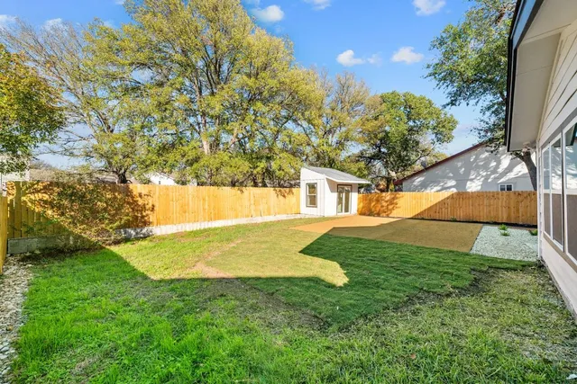 a view of yard with swimming pool and green space