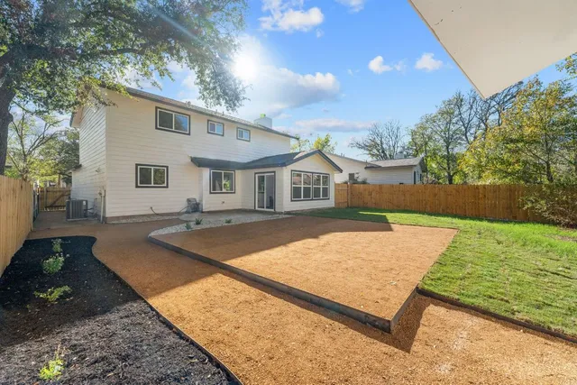 a view of a house with backyard and sitting area