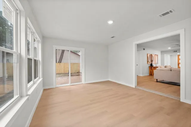a view of a big room with wooden floor and a cabinet