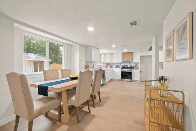 a view of a dining room with furniture and a table