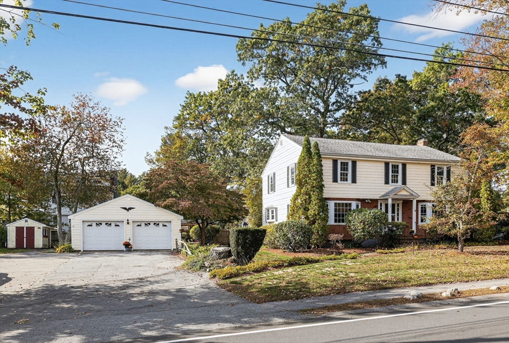 77 Whipple Road Billerica, MA 01821 - Photo 1 of 30 a view of a white house with a yard and large tree