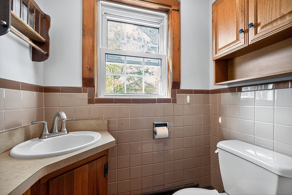 77 Whipple Road Billerica, MA 01821 - Photo 13 of 30 a bathroom with a toilet sink and mirror