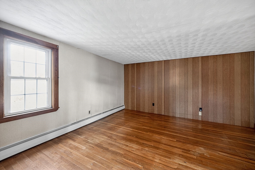 77 Whipple Road Billerica, MA 01821 - Photo 18 of 30 wooden floor in an empty room with a window