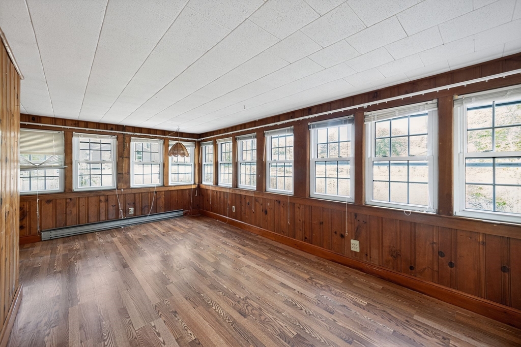 77 Whipple Road Billerica, MA 01821 - Photo 20 of 30 a view of an empty room with wooden floor and a window