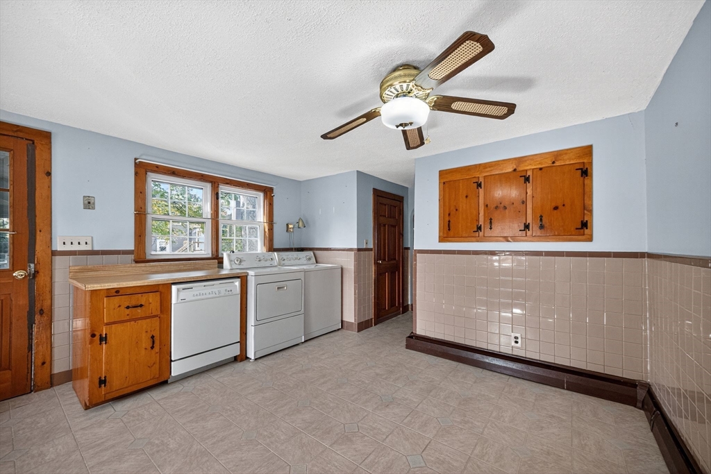 77 Whipple Road Billerica, MA 01821 - Photo 25 of 30 a large kitchen with stainless steel appliances granite countertop a stove a sink and a refrigerator