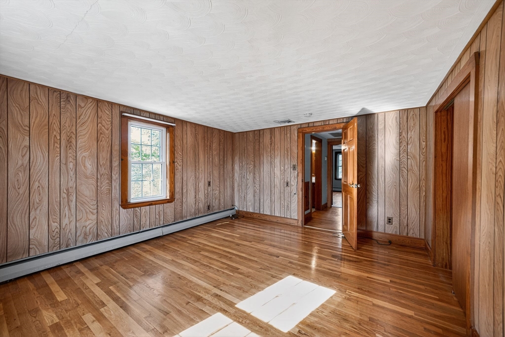 77 Whipple Road Billerica, MA 01821 - Photo 26 of 30 wooden floor in an empty room with a window