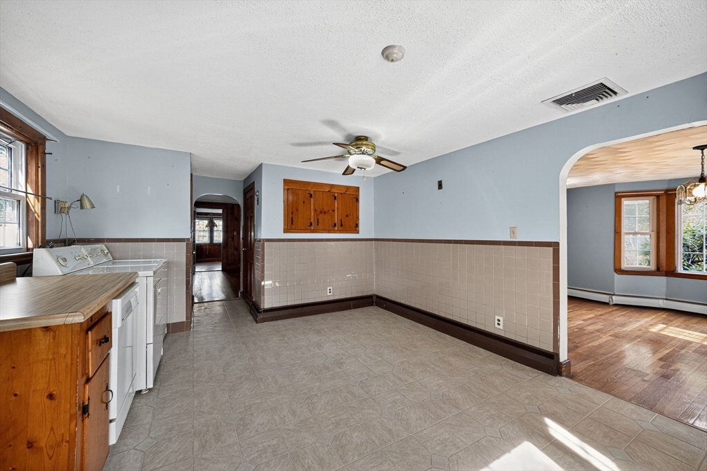 77 Whipple Road Billerica, MA 01821 - Photo 4 of 30 a view of a kitchen with a sink cabinets and a window