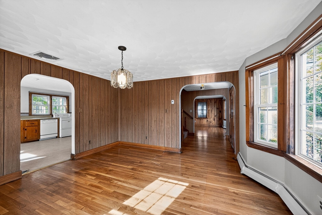77 Whipple Road Billerica, MA 01821 - Photo 6 of 30 an empty room with wooden floor mirror and windows