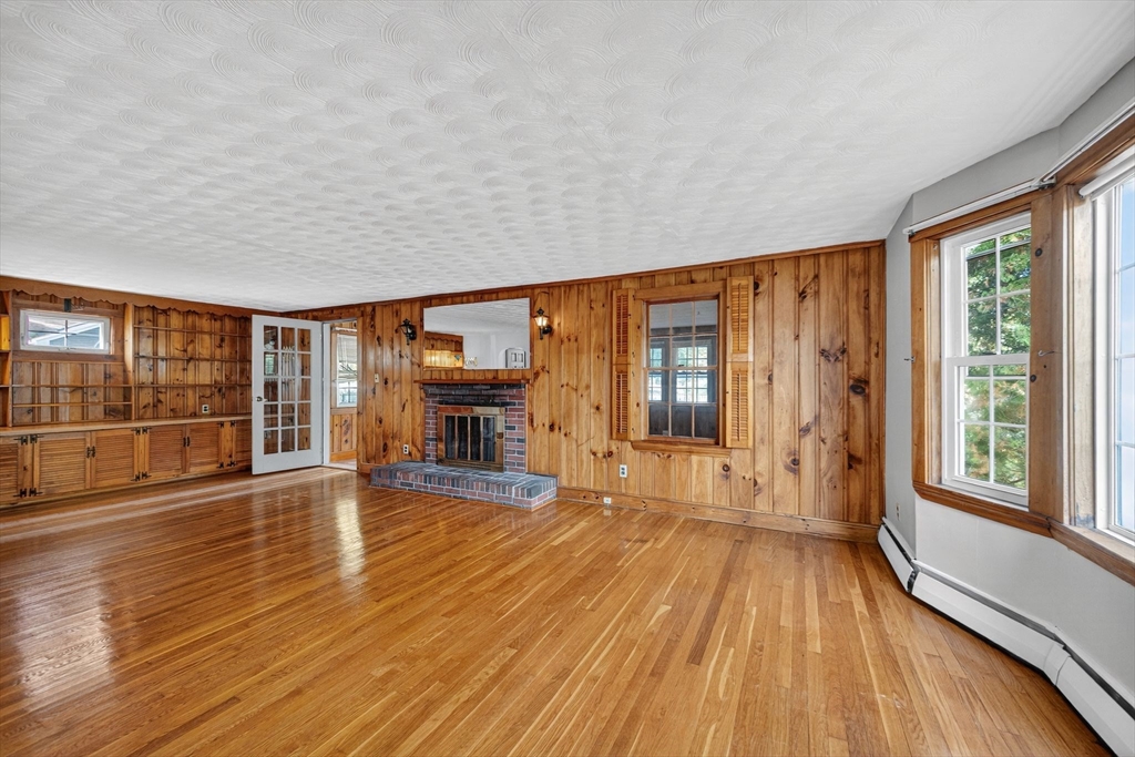 77 Whipple Road Billerica, MA 01821 - Photo 7 of 30 wooden floor in an empty room with a window