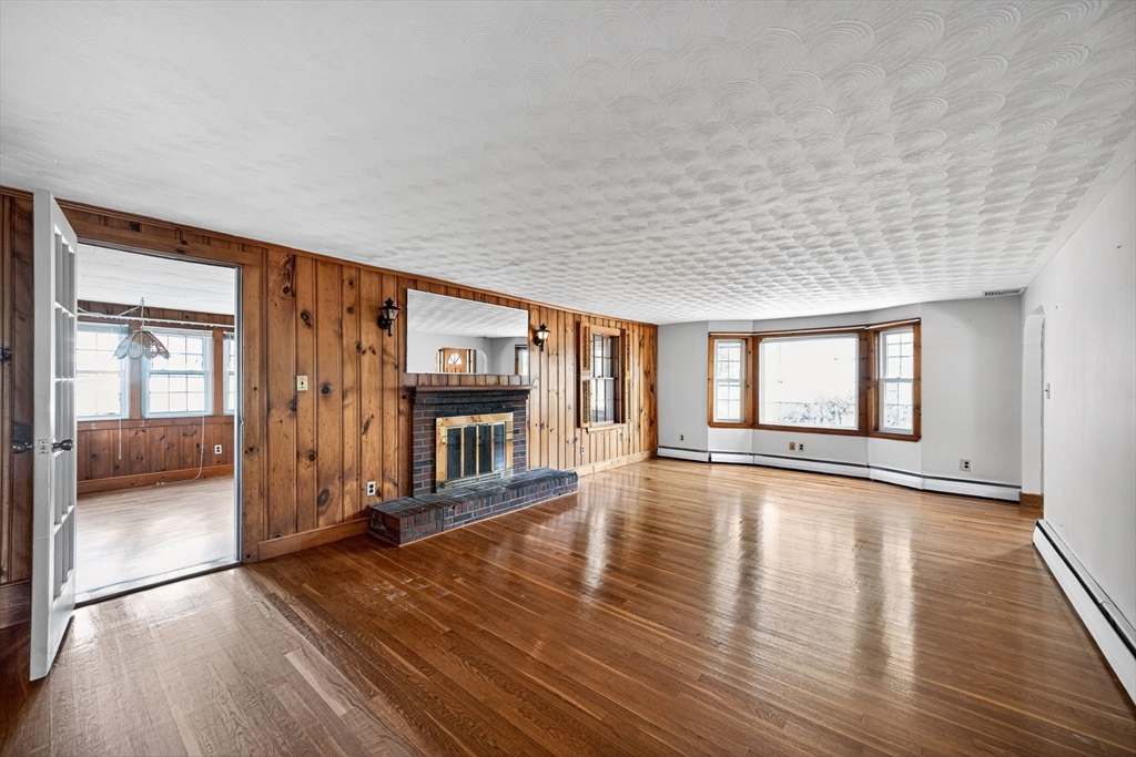 77 Whipple Road Billerica, MA 01821 - Photo 9 of 30 a view of an empty room with wooden floor and a window