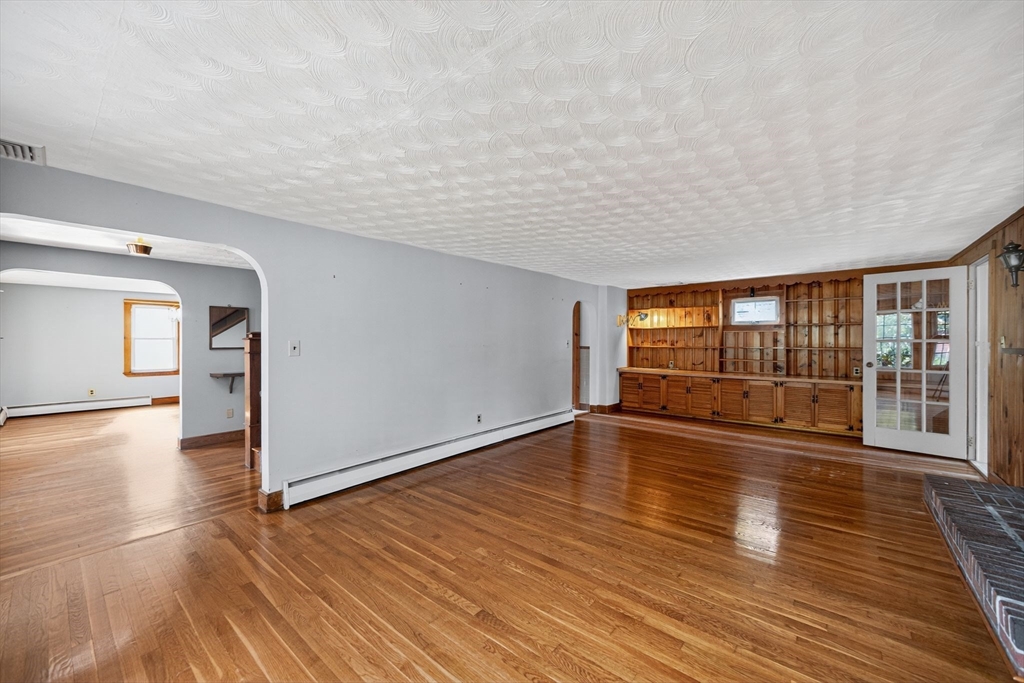 77 Whipple Road Billerica, MA 01821 - Photo 10 of 30 a view of empty room with wooden floor and fan