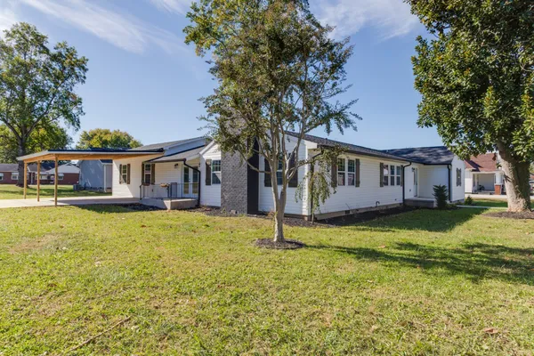 a house that has a big yard in front of it