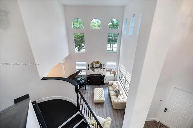 a view of a room with furniture and wooden floor