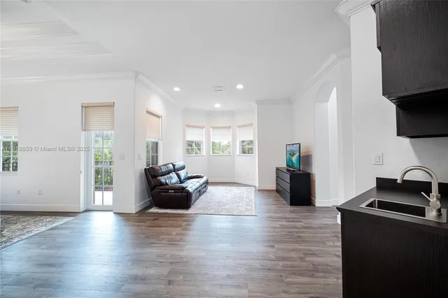 a bedroom with a bed a chair and a large window