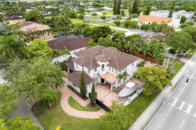 an aerial view of residential houses with outdoor space and street view