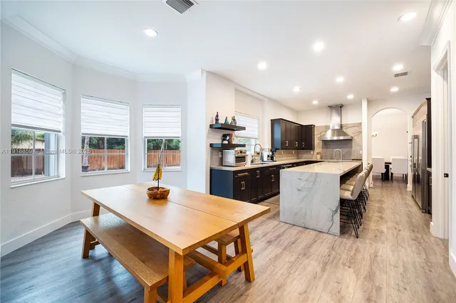 a large kitchen with stainless steel appliances kitchen island granite countertop a large counter top stainless steel appliances and a window