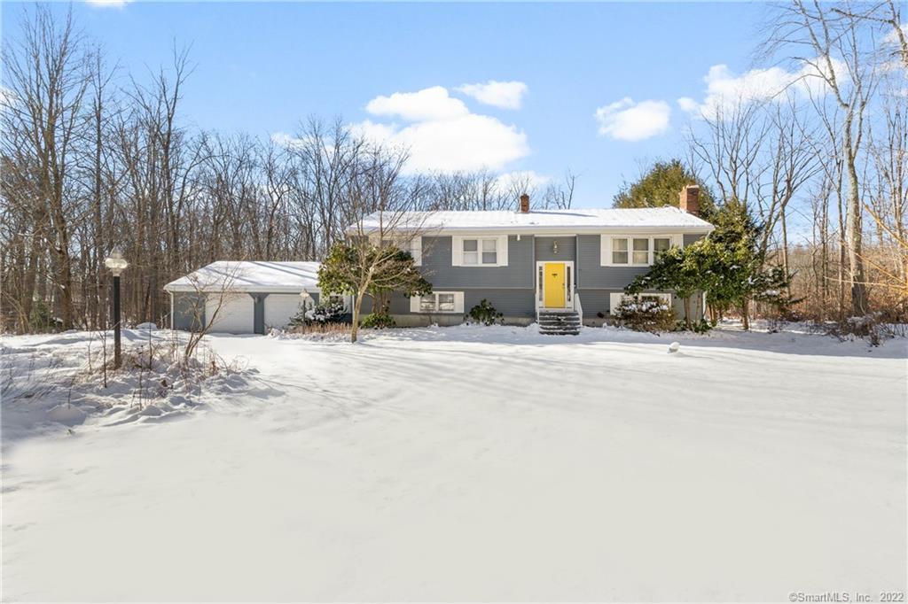 a view of a house with a snow in the yard