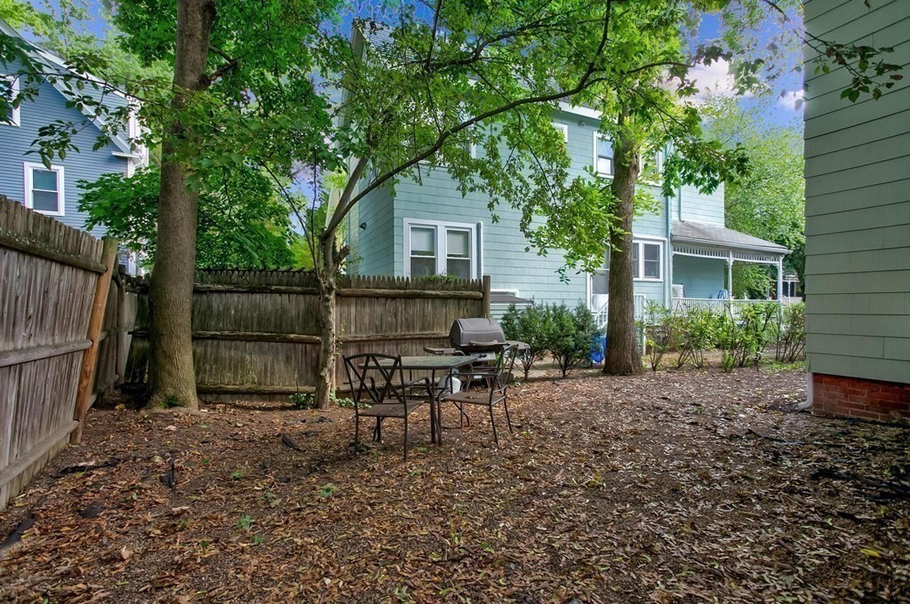 59 Creighton Street, Unit 2 Cambridge, MA 02140 - Photo 11 of 38 a backyard of a house with table and chairs