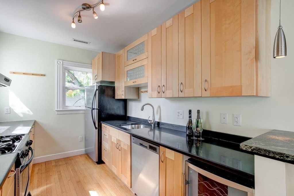 59 Creighton Street, Unit 2 Cambridge, MA 02140 - Photo 17 of 38 a kitchen with granite countertop a sink stainless steel appliances a counter space and cabinets