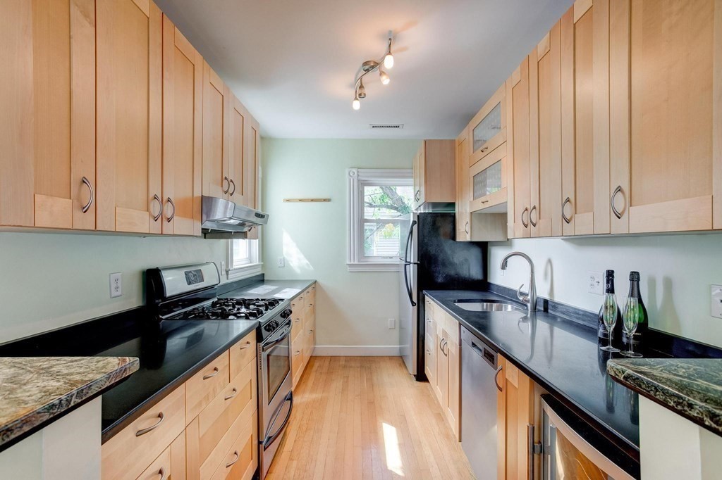 59 Creighton Street, Unit 2 Cambridge, MA 02140 - Photo 19 of 38 a kitchen with stainless steel appliances a sink a stove and cabinets