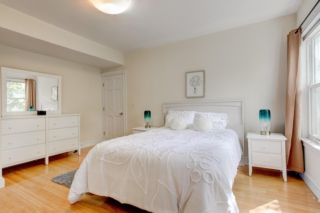 59 Creighton Street, Unit 2 Cambridge, MA 02140 - Photo 20 of 38 a bedroom with a bed and a large window