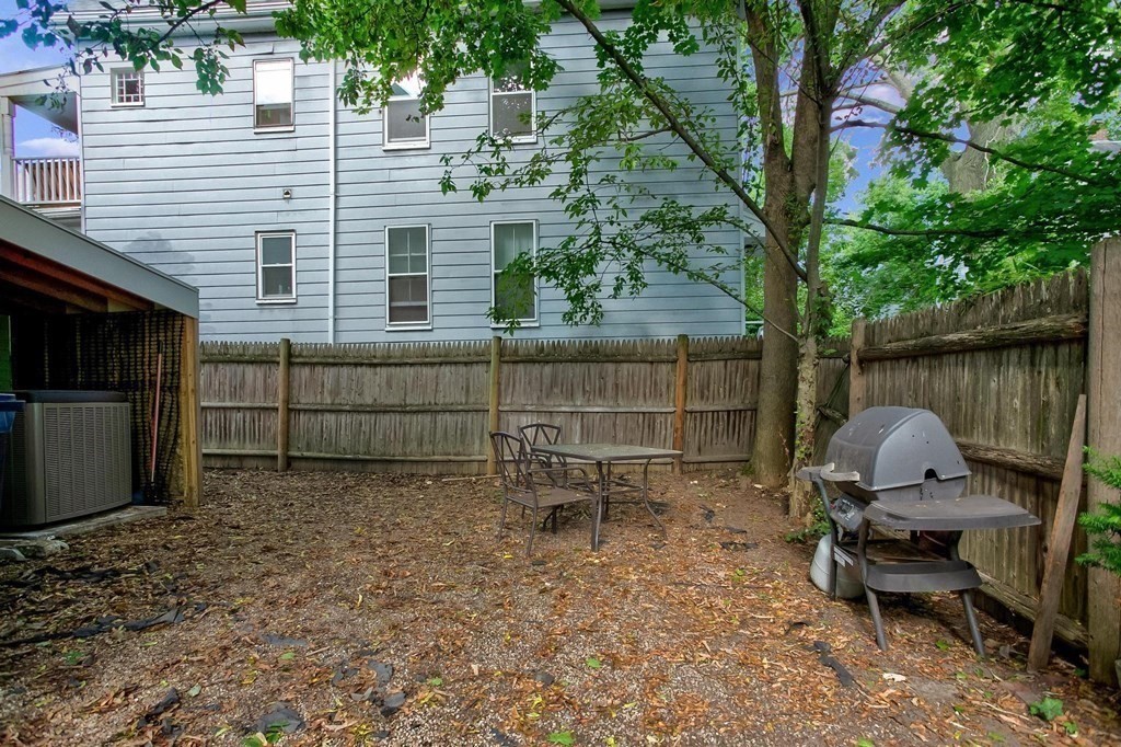 59 Creighton Street, Unit 2 Cambridge, MA 02140 - Photo 25 of 38 a backyard of a house with table and chairs