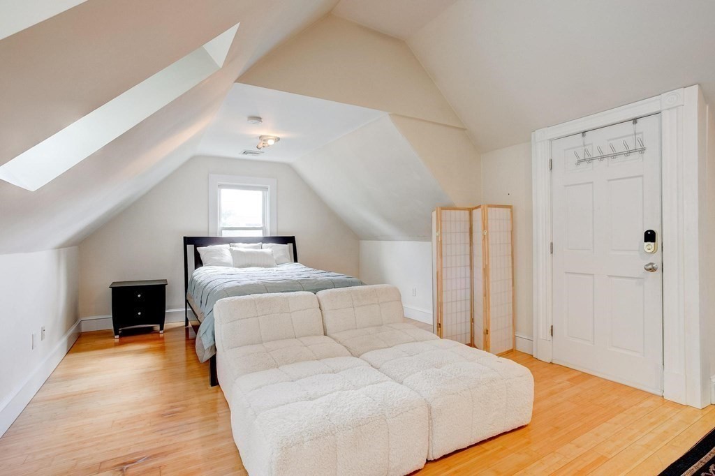 59 Creighton Street, Unit 2 Cambridge, MA 02140 - Photo 26 of 38 a spacious bedroom with a bed and a view of kitchen