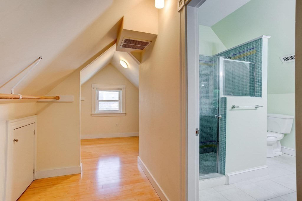 59 Creighton Street, Unit 2 Cambridge, MA 02140 - Photo 32 of 38 a view of a hallway with wooden floor and a bathroom