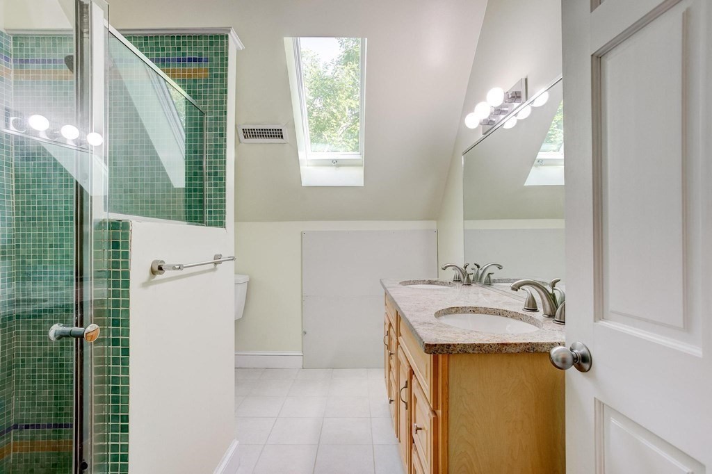 59 Creighton Street, Unit 2 Cambridge, MA 02140 - Photo 33 of 38 a bathroom with a sink a mirror and a shower